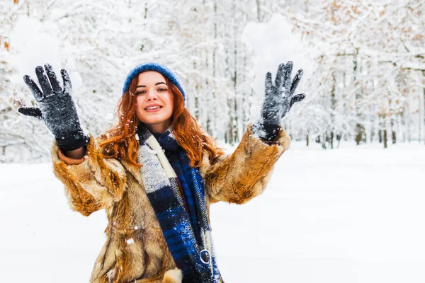 Jovem bela mulher brincando com a neve na floresta de inverno — Fotografia de Stock