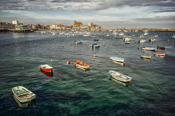 Castro Urdiales port city on the Bay of Biscay, northern Spain, Cantabria. Far view for a castle and port with boats ahead of it.