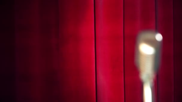 赤のカーテンの背景の上にレトロなマイク — ストック動画
