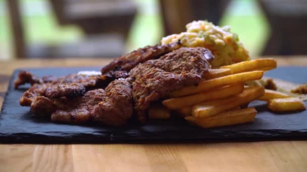 Dish with French fries and pork meat — Stock Video