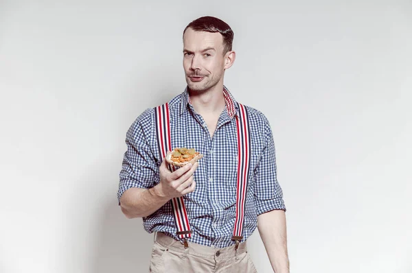 Hungry Bavarian man eating sandwich after yodeling. He seems to like his sandwich with paprykaz szczecinski and pickled cucumber.