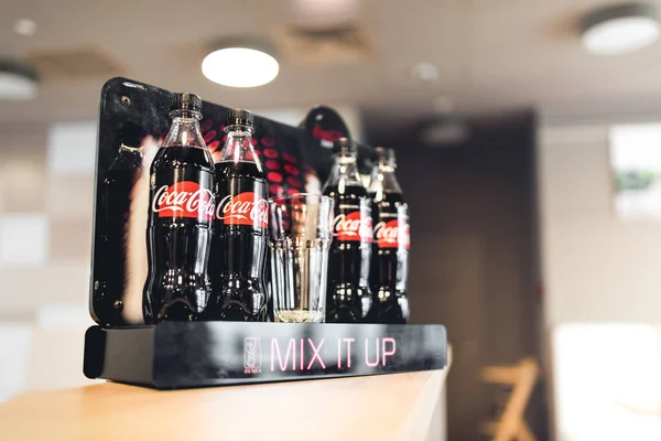 stock image Classic Coca-Cola bottles standing at the bar, placed in Coca-Cola advertising stand. Hotel Boutique, Katowice 22 May 2017. Poland. 