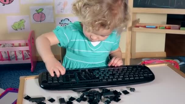 Sweet little child boy girl playing with broken keyboard keys — Stock Video