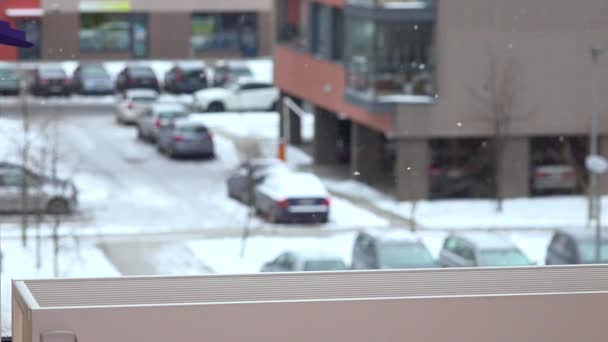 Child put teddy bear toy friend with scarf on radiator near window. Snow fall — Stock Video