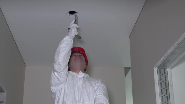 Professional Worker In Work Wear Make Drywall Ceiling Holes For
