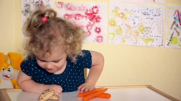 Schattig klein meisje wilt eten wortelen niet honing cake — Stockvideo