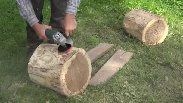 Escultor preparar madeira árvore log para o trabalho de arte. Casca de lixamento com ferramenta de lixadeira. Fecha a porta. 4K — Vídeo de Stock