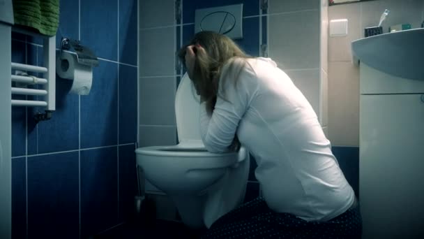 Young woman vomiting in bathroom wc - morning sickness during pregnancy — Stock Video