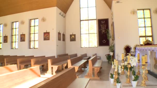 Awesome interior of modern new church. Altar pew and paintings in god house — Stock Video