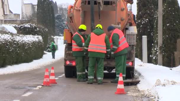 Hulpdiensten van afvalwater afvoer verwijderen. Werknemers met speciale stortbak vrachtwagen — Stockvideo