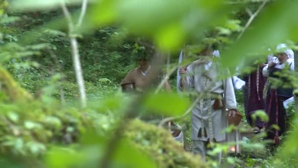 Pagan people procession through forest — Stock Video