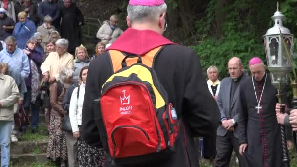 Sacerdote con mochila madrileña y religiosos se arrodillan y rezan — Vídeo de stock