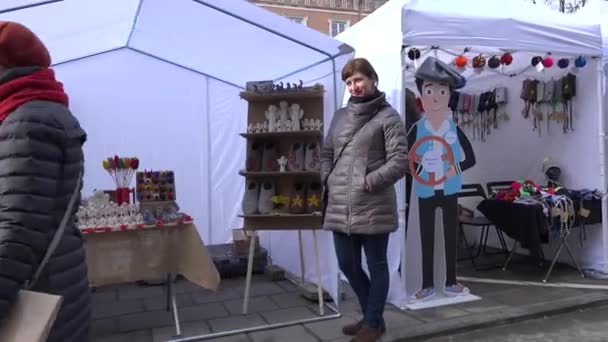 Mulher sorridente e outros comerciantes vendem vários produtos de lã na feira Casimir — Vídeo de Stock