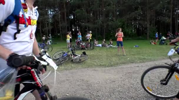 Male and female bicyclist athletes resting after sport competition race. — Stock Video