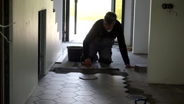 Handyman Level Glue With Trowel And Lay Hexagon Shape Tiles On