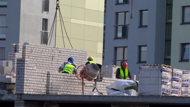 Facharbeiter-Team baut Hauswand aus weißen Ziegeln — Stockvideo