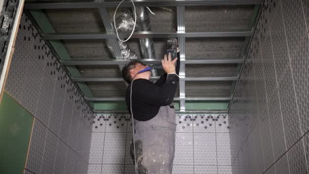 Worker Drill Hole To Fix Ceiling Profiles Dust Falling On Handyman Man