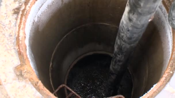 Workers with hose pump sewerage drain from drainage hole. Emergency service — Stock Video