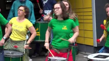 Young active people playing drums.