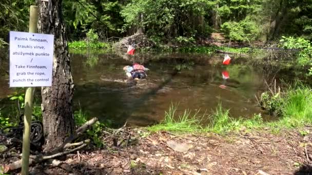 Participantes del concurso de orientación en el puesto de control bajo aguas pantanosas . — Vídeos de Stock