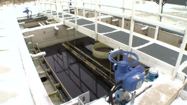 Blue big stopcock valve in water treatment plant and dirty liquid — Stock Video