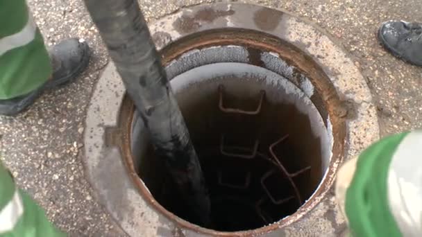 Specialist men pumping off sewage drainage with thick tube pipe — Stock Video