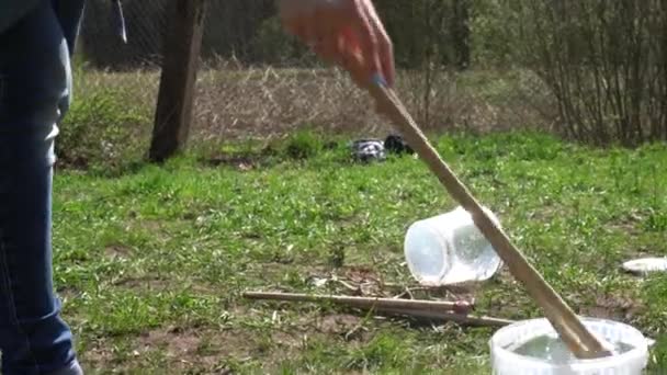 Female woman hands with sticks blowing soap bubbles. Gimbal movement — Stock Video