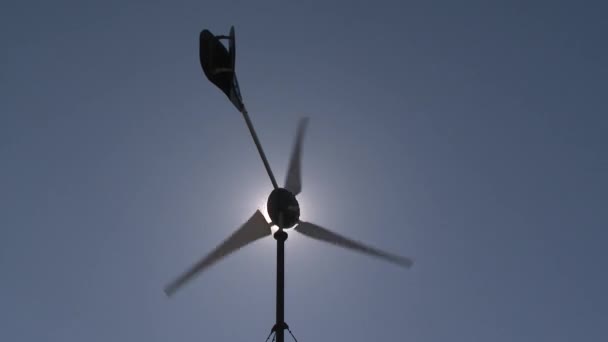 Sun light visible through wind turbine energy generator propeller spin — Stock Video