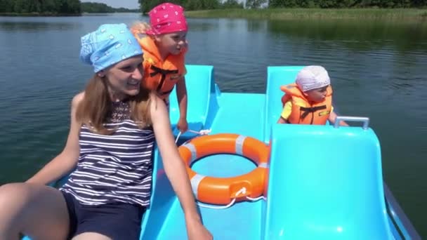Madre joven con niños niño y niña se divierten en barco catamarán. Movimiento del cardán — Vídeos de Stock