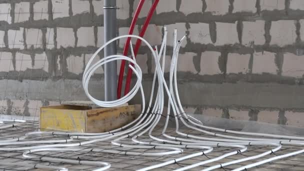 Underfloor heating system pipes hoses at construction site. Zoom out — Stock Footage Underfloor heating system pipes hoses at construction site. Zoom out Royalty Free Stock Footage