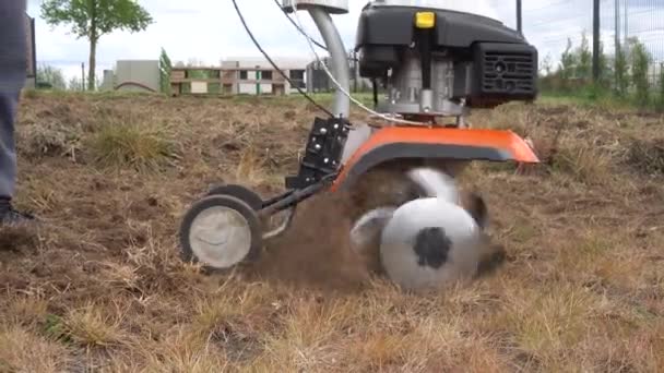 Private house yard cultivating with cultivator. Gimbal movement closeup shot — Stock Video