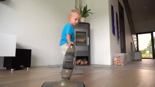 One happy child, pretty blond boy cleaning dust in room. Mother helper son — Stock Video