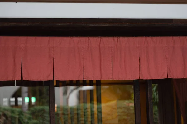 The curtain-like fabric that hangs in front of traditional Japan