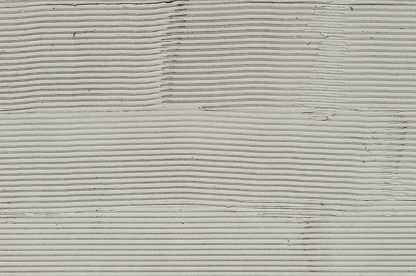 El fragmento de la pared con los arañazos y las grietas. Respaldo de cemento blanco — Foto de Stock