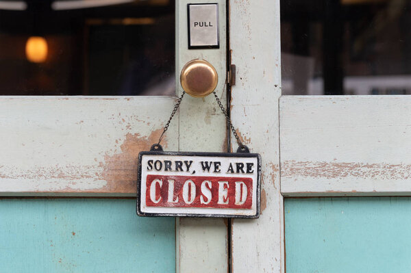 Sorry we are closed sign hanging outside a restaurant, store, of Stock Photo