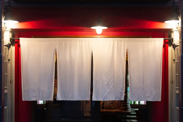 The curtain-like fabric that hangs in front of traditional Japan