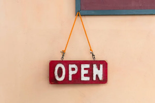 Open sign hanging on wooden wall in restaurant. — Stock Photo, Image