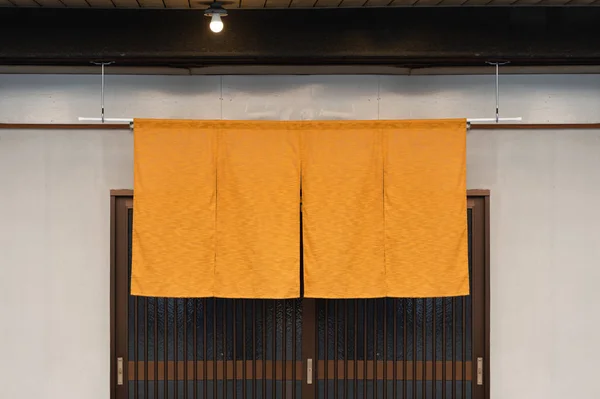 The curtain-like fabric that hangs in front of traditional Japan