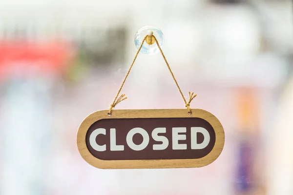 sorry we are closed sign hanging outside a restaurant, store, office or other