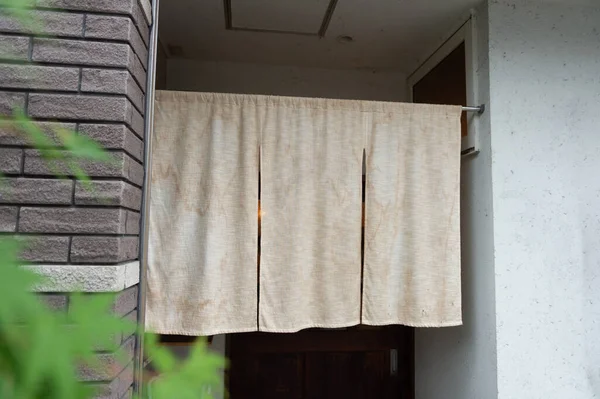 The curtain-like fabric that hangs in front of traditional Japanese restaurants and shops not only serves as a signboard, but holds a larger meaning,