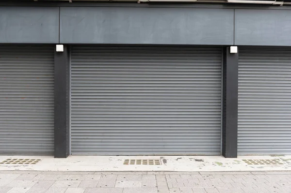 A closeup shot of automatic metal roller door used in factory, storage, garage, and industrial warehouse. The corrugated and foldable metal sheet offer space saving and provide urban and rustic feel