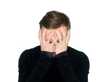 Umutsuzluk genç adam portresi tarafından iki eli yüzü kapalı. Beyaz bir arka plan üzerinde izole.