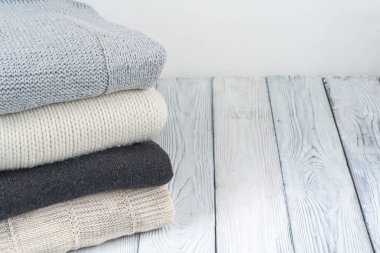 Örgü yün kazak. Ahşap zemin üzerine örme kış elbise yığını