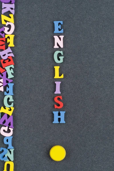 English word on black board background composed from colorful abc alphabet block wooden letters, copy space for ad text. Learning english concept