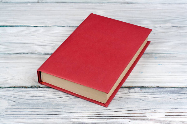 Open hardback book, on wooden table. natural background . Back to school. Copy space for text