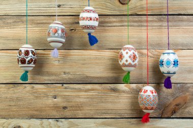 Mutlu paskalya kartı. Ahşap masa arka plan üzerinde renkli parlak Paskalya yumurtaları. Metin için yer kopyalayın