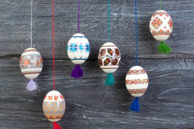 Mutlu paskalya kartı. Gri ahşap masa arka plan üzerinde renkli parlak Paskalya yumurtaları. Metin için yer kopyalayın