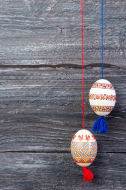 Mutlu paskalya kartı. Gri ahşap masa arka plan üzerinde renkli parlak Paskalya yumurtaları. Metin için yer kopyalayın