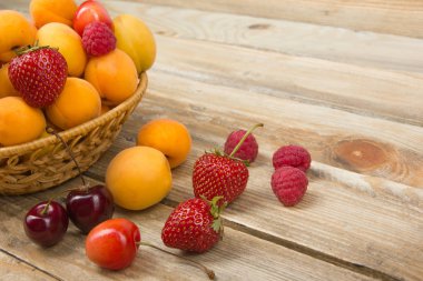 Bir kase rustik ahşap masa üzerinde çeşitli yaz taze çilek. . Antioksidan, detoks diyet, organik meyve