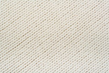 Süveter ya da atkı kumaş dokusu büyük örgü. Örülmüş forma ve kabartma desenli. Yün el yapımı makine, el yapımı.